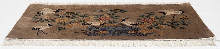 A silke figural rug, China, later part of the 20th century, ca. 92 x 170 cm.