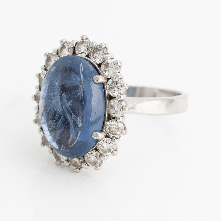 Ring with cabochon-cut sapphire and brilliant-cut diamonds.
