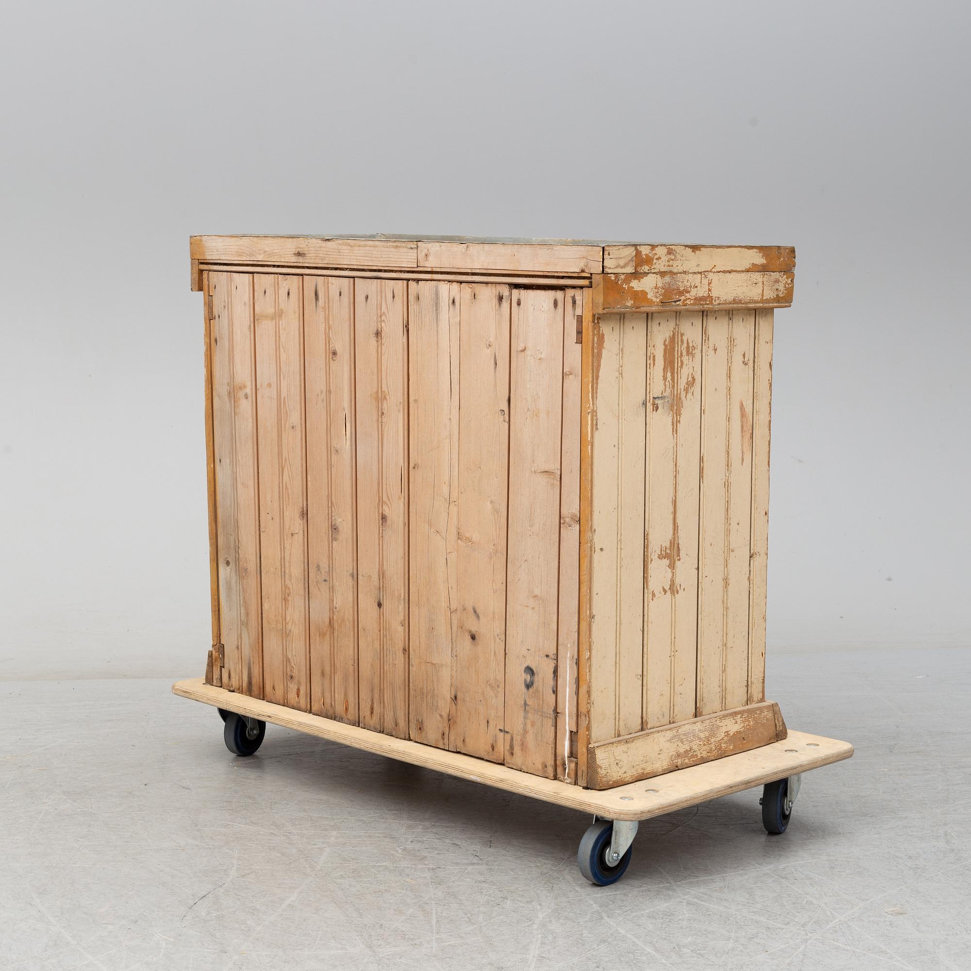 A late 19th Century cabinet with zink top.