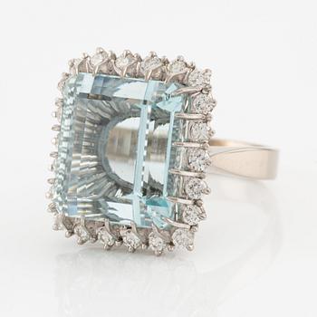 An 18K white gold Engelbert ring set with a aquamarine and round brilliant-cut diamonds.