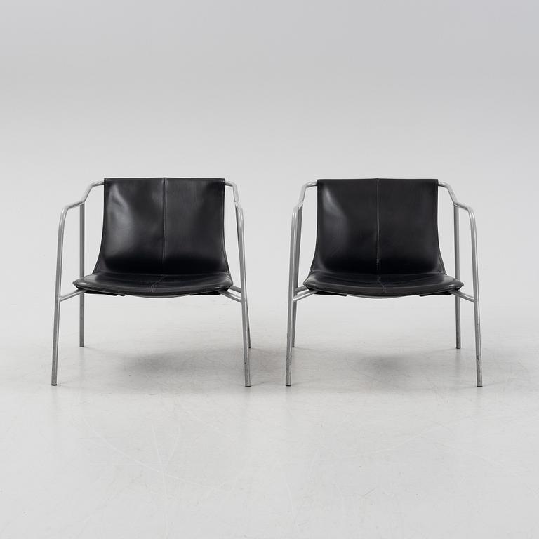 A pair of leather-upholstered easy chairs from Fasem, Italy.