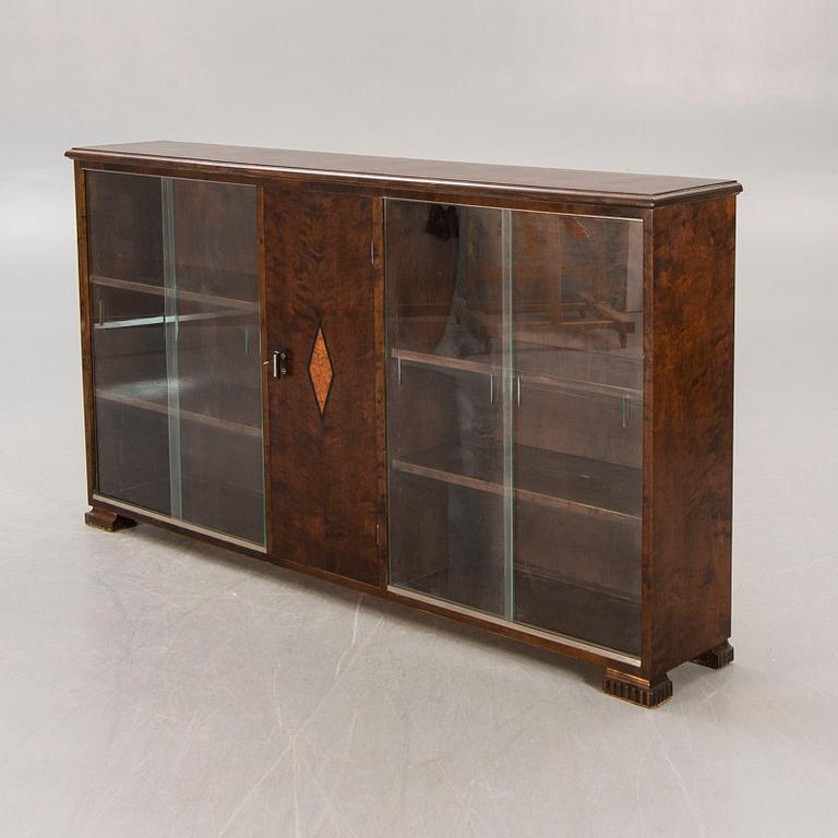 A 1930s birch book cabinet.