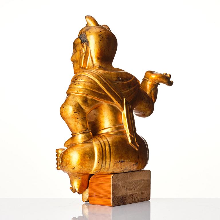 A gilt and lacquered wooden sculpture of a guardsman, Qing dynasty, 18th century.