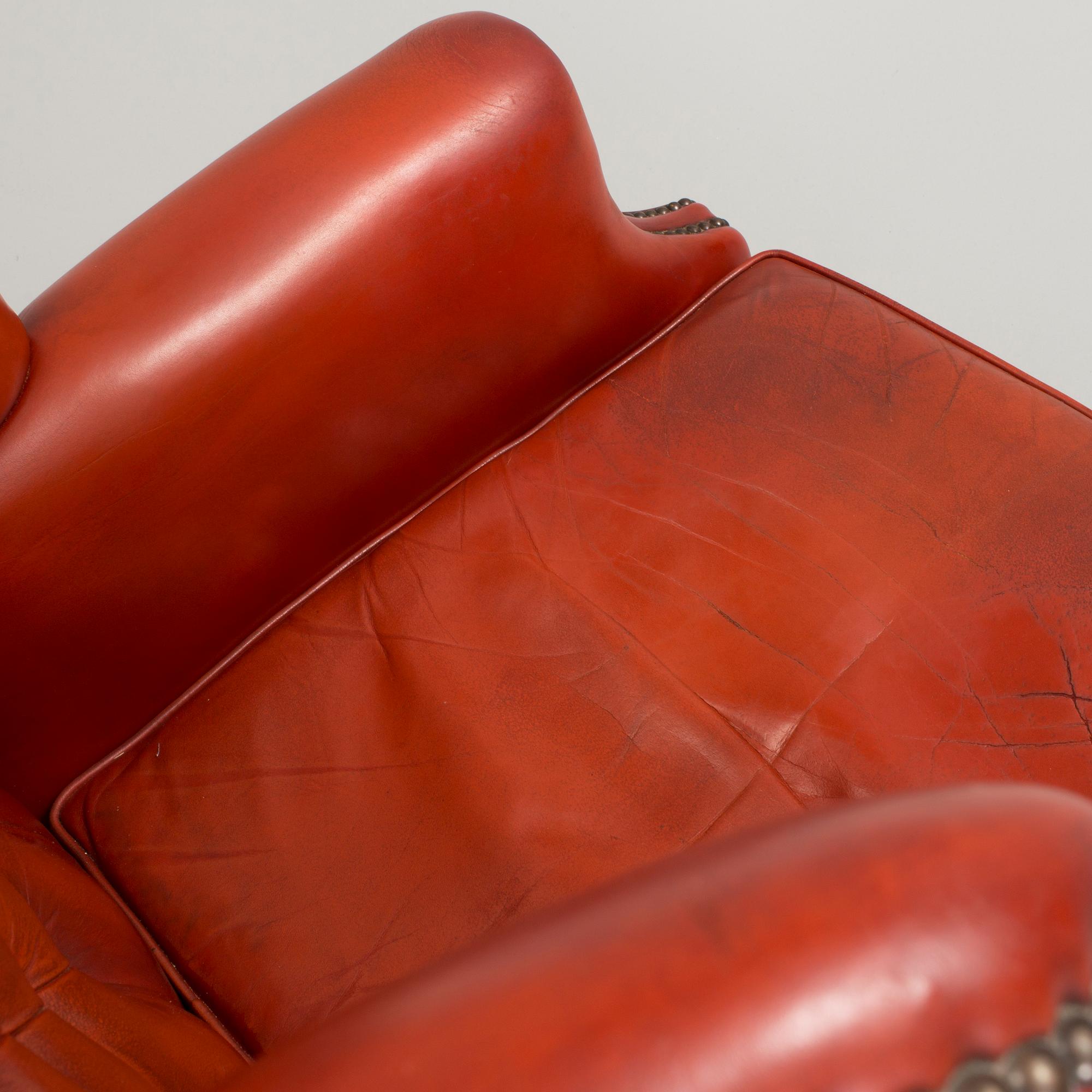 a 20h Century red lether armchair.