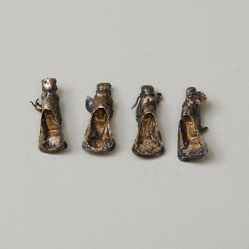 A set of four silver figure shaped buttons, Qing dynasty.