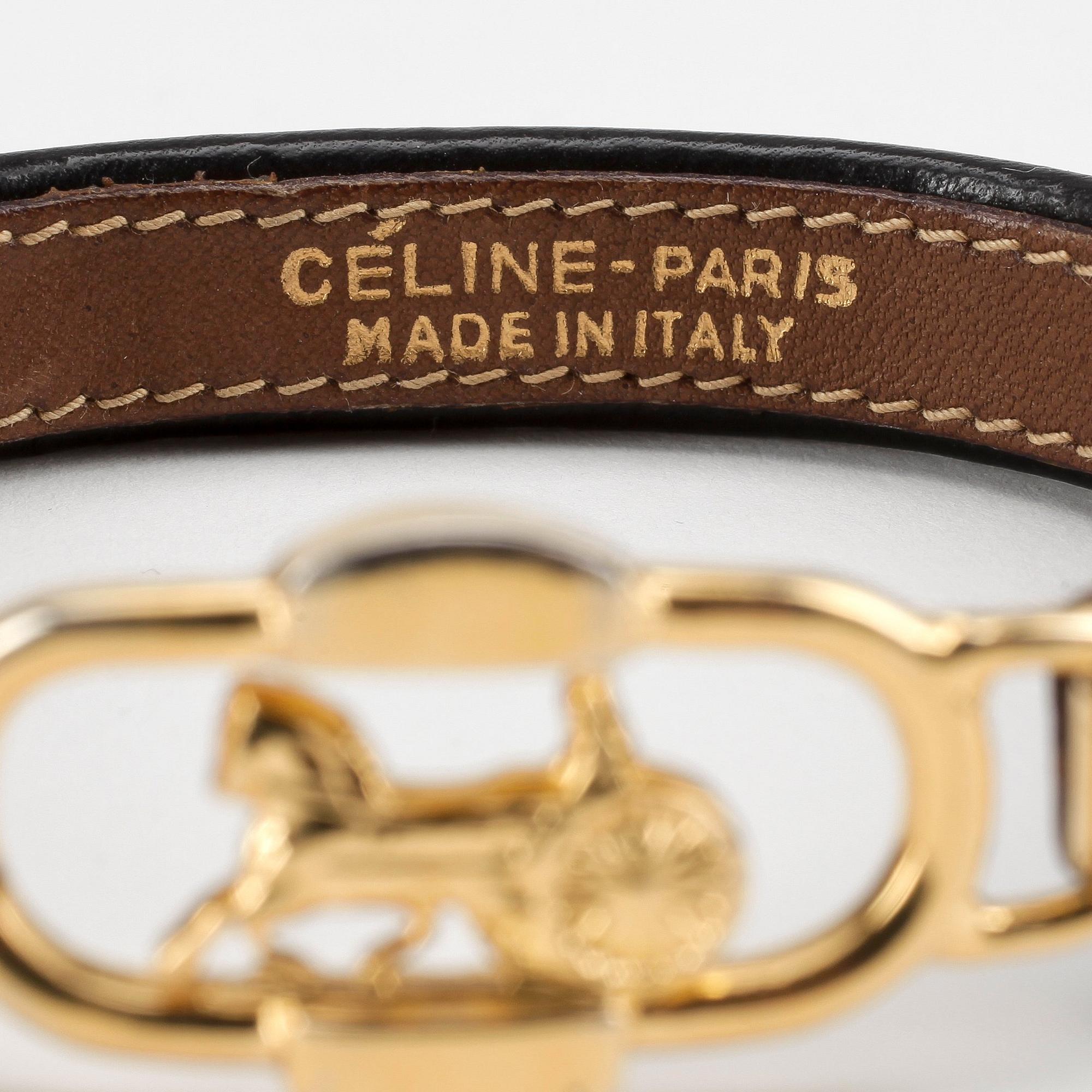 CÉLINE, a black leather bracelet.