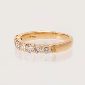 An 18K gold half-eternity ring set with round brilliant-cut diamonds.