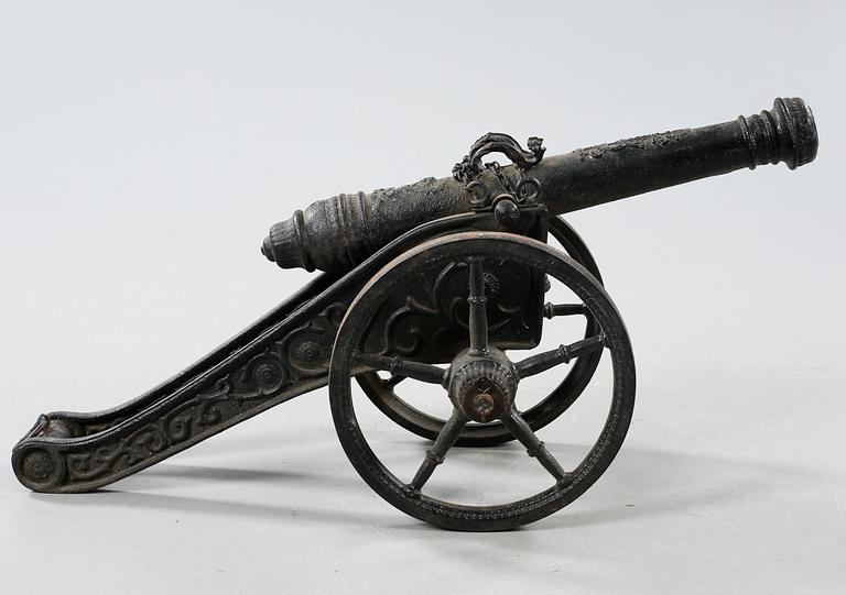 A small cast iron cannon, 19th or early 20th century.