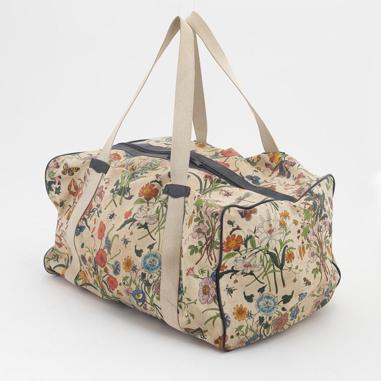 Gucci, a 'Flora' weekend bag and umbrella.