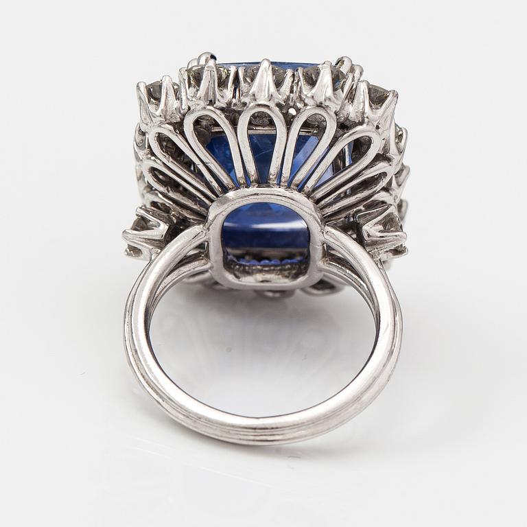 A platinum ring with a ca. 18.00 ct sapphire and ca. 3.00 cts of diamonds. With certificates.