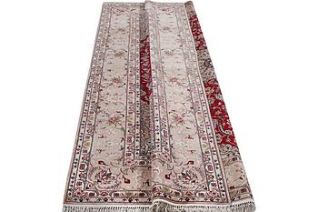 An Esfahan carpet, part silk, signed Rahmi, c. 298 x 206 cm.