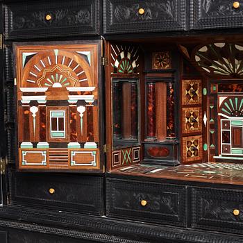 A Louis XIV and Louis XIV-style carved ebony, ivory and tortoiseshell-inlaid cabinet on stand, 17th and 19th century.