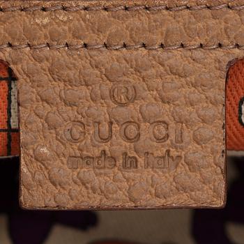 GUCCI, a dark beige leather handbag.