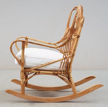 A Josef Frank ratten and beech rocking chair, Svenskt Tenn, model 1077, 1940's-50's.