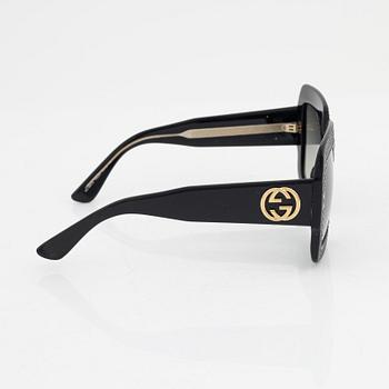 Gucci, a pair of black plastic and rhinestone sunglasses.