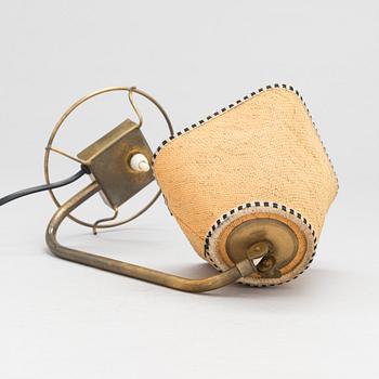 A mid-20th-century table lamp
/wall light for Idman.