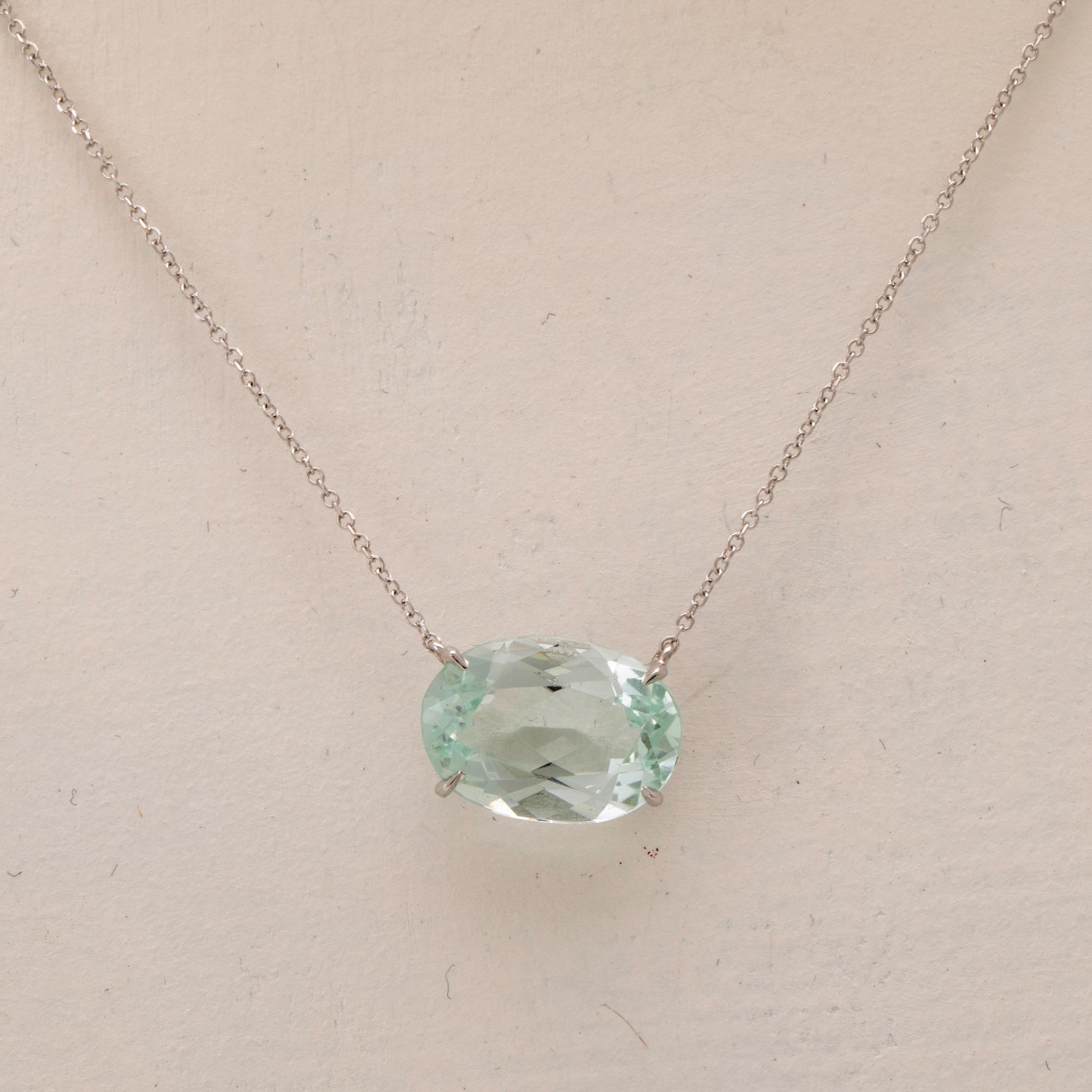 An 18K white gold necklace with an oval faceted aquamarine.