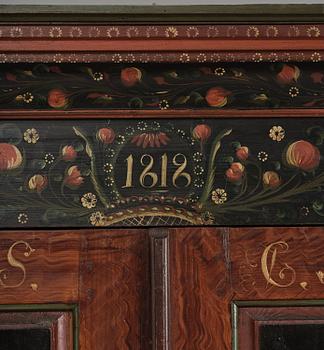 A Swedish polychrome painted folk art corner cabinet, dated 1818.