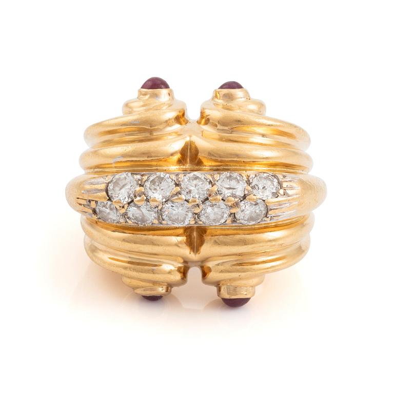 An 18K gold ring set with round brilliant-cut diamonds and cabochon-cut rubies.