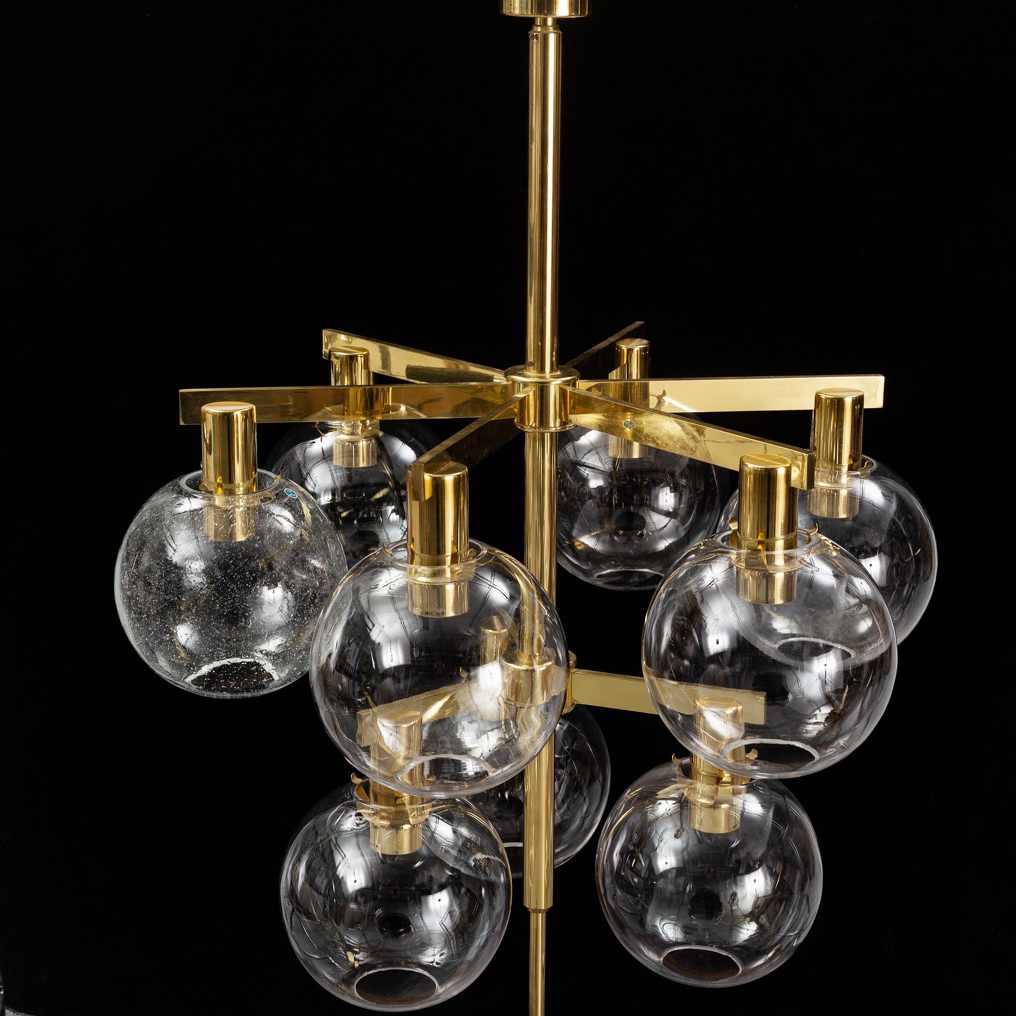 A brass chandelier with glass globes by Hans Agne Jakobsson, Markaryd.