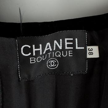 CHANEL, a two-piece suit consisting of jacket and skirt.