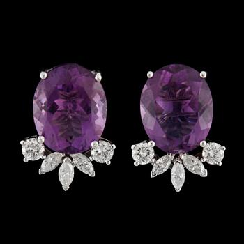 17. A pair of amethyst and diamond, circa 0.60 ct, earrings.