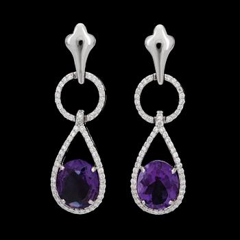 79. A pair of amethyst and diamond earrings. Amethysts 3.96 cts. Diamonds 0.62 ct.