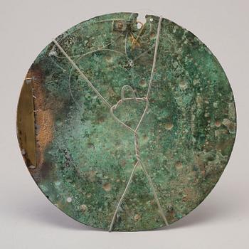 Three 20th century stone objects, with one bronze shield.