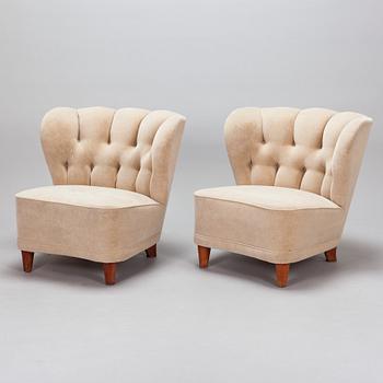 A pair of mid-20th century armchairs.