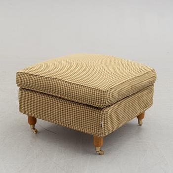 A foot stool by Fogia dressed in Ralph Lauren fabric.