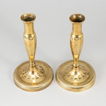 A pair of brass candlesticks, first half of the 19th century.