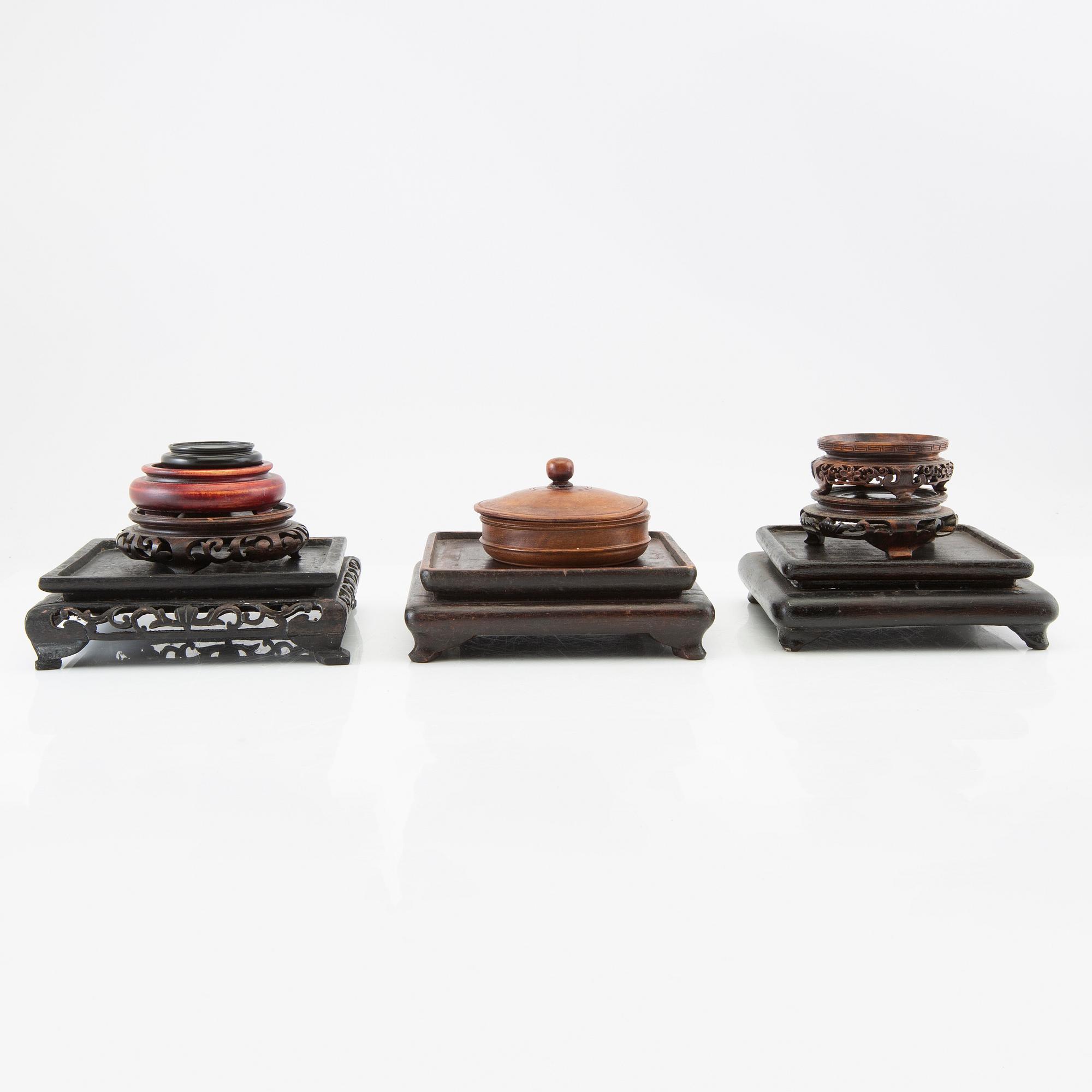 A set of approximately 26 Chinese wooden stands, 20th century.