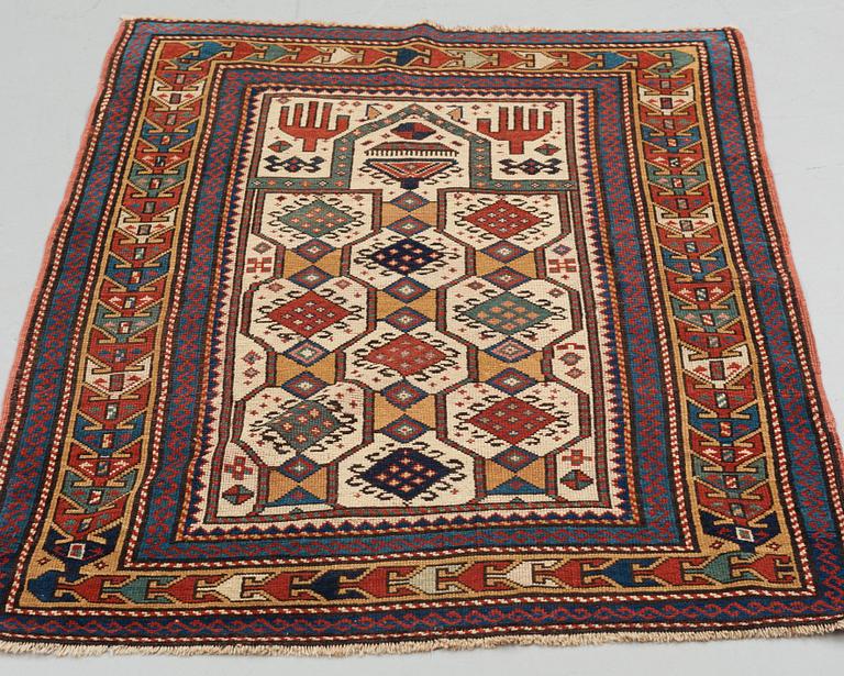 A RUG, an antique Caucasian prayer rug, Czar Russia, ca 144-151 x 103-106 cm.