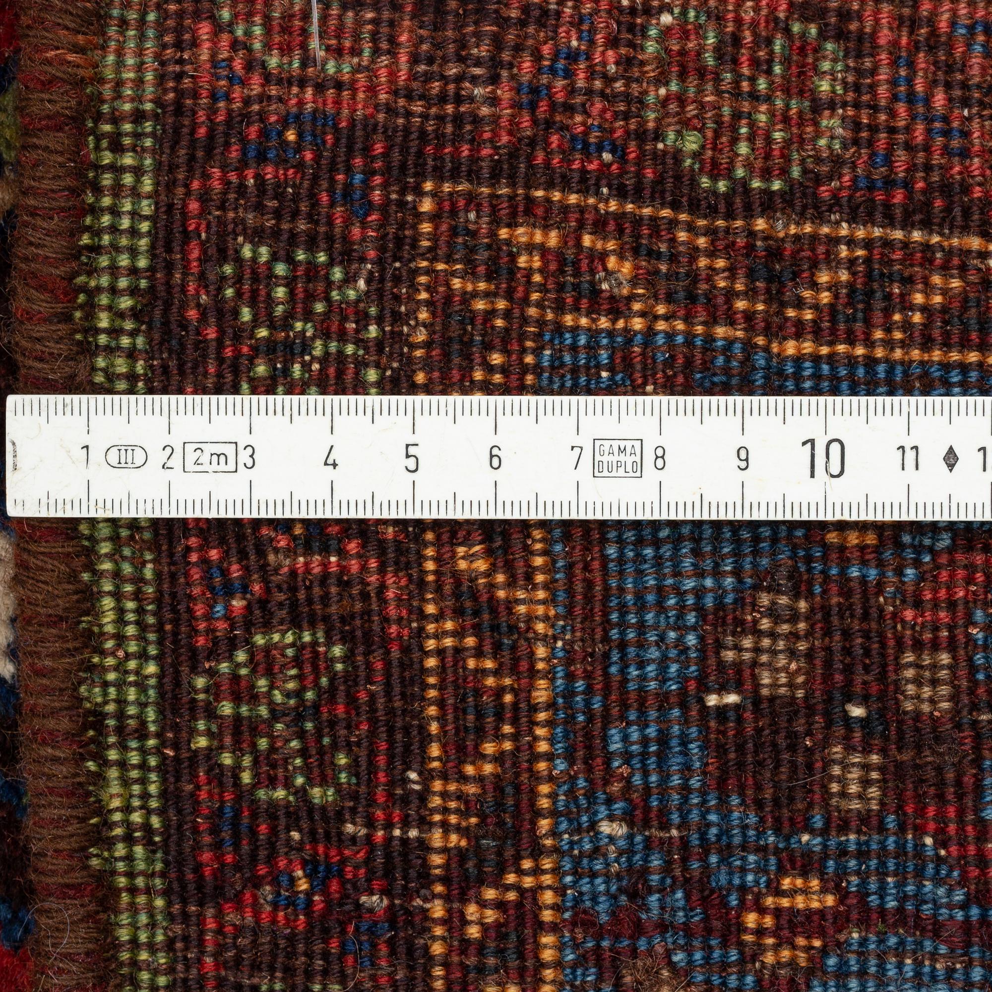 An oriental rug, semi antique, probably Baluch, c. 210 x 170 cm.