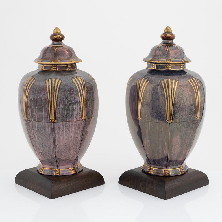 Josef Ekberg, a pair of creamware lidded urns, Gustavsberg, dated 1927.