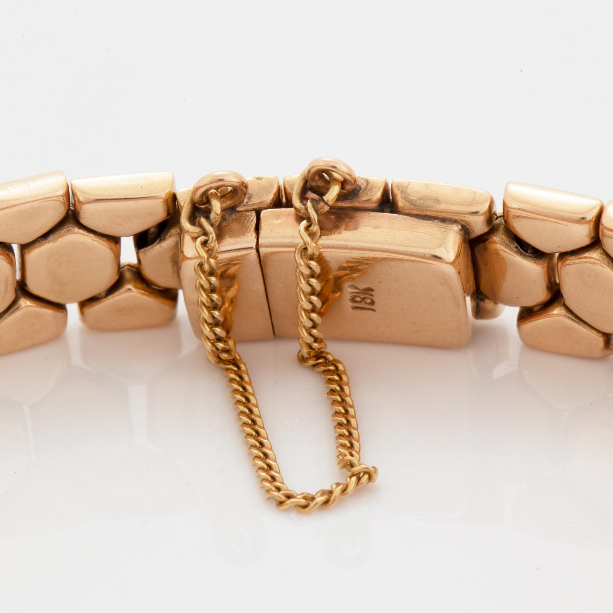 An 18K gold bracelet.