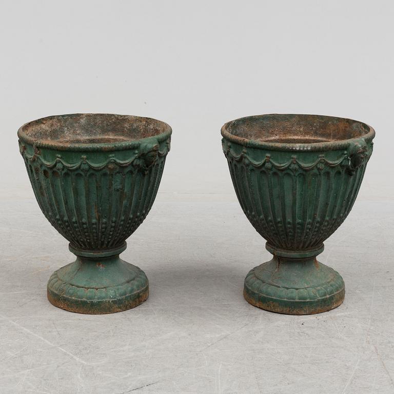 A pair of early 20th century iron garden urns.