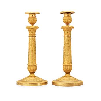 515. A pair of French Empire early 19th century candlesticks.