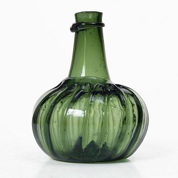 A green twisted glass bottle, 18th century.