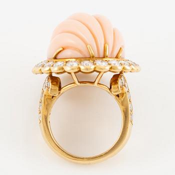 An 18K gold and coral Cartier ring set with round brilliant-cut diamonds.