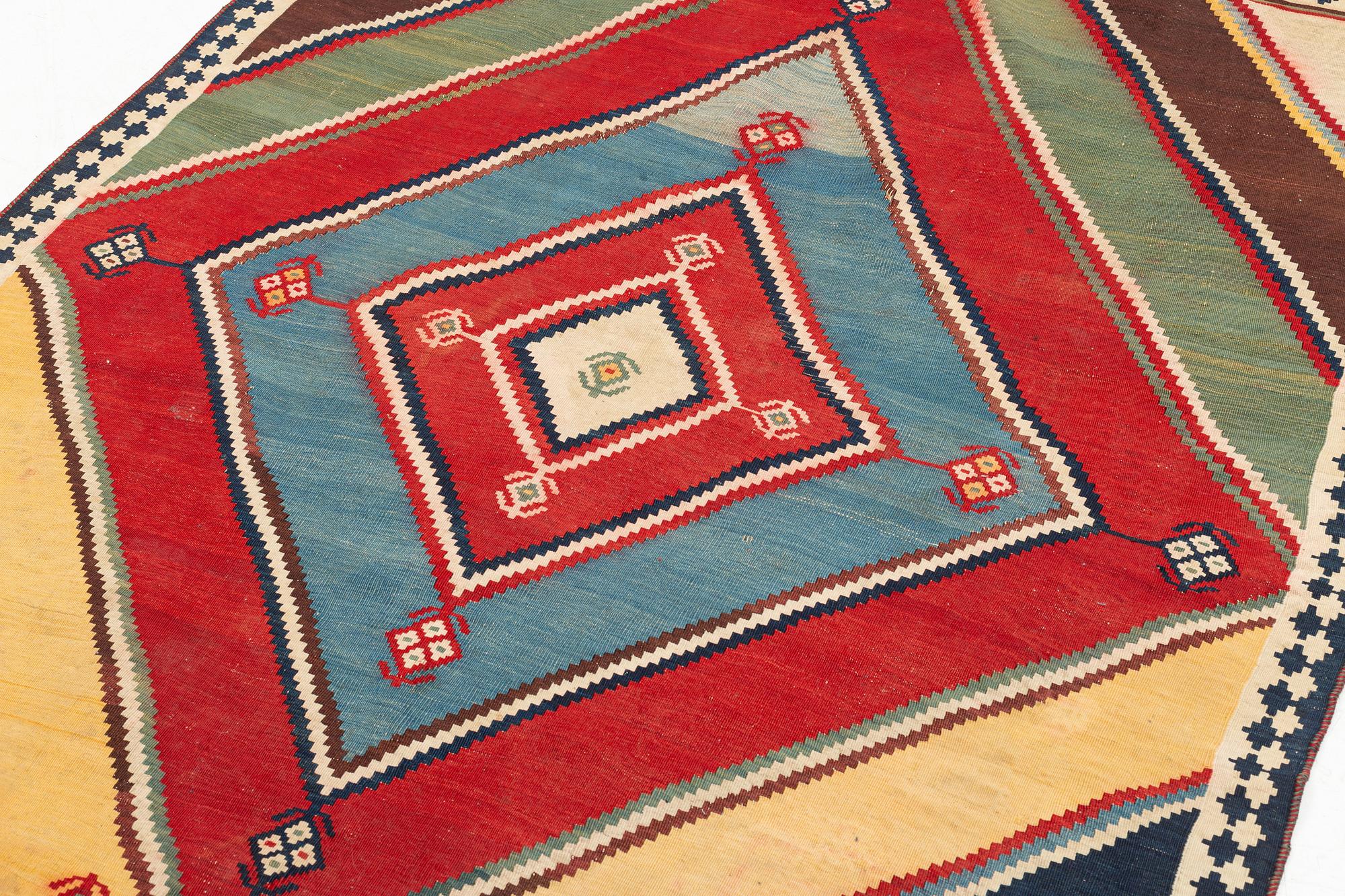 An antique Qashqai kilim rug, c. 380 x 148 cm.