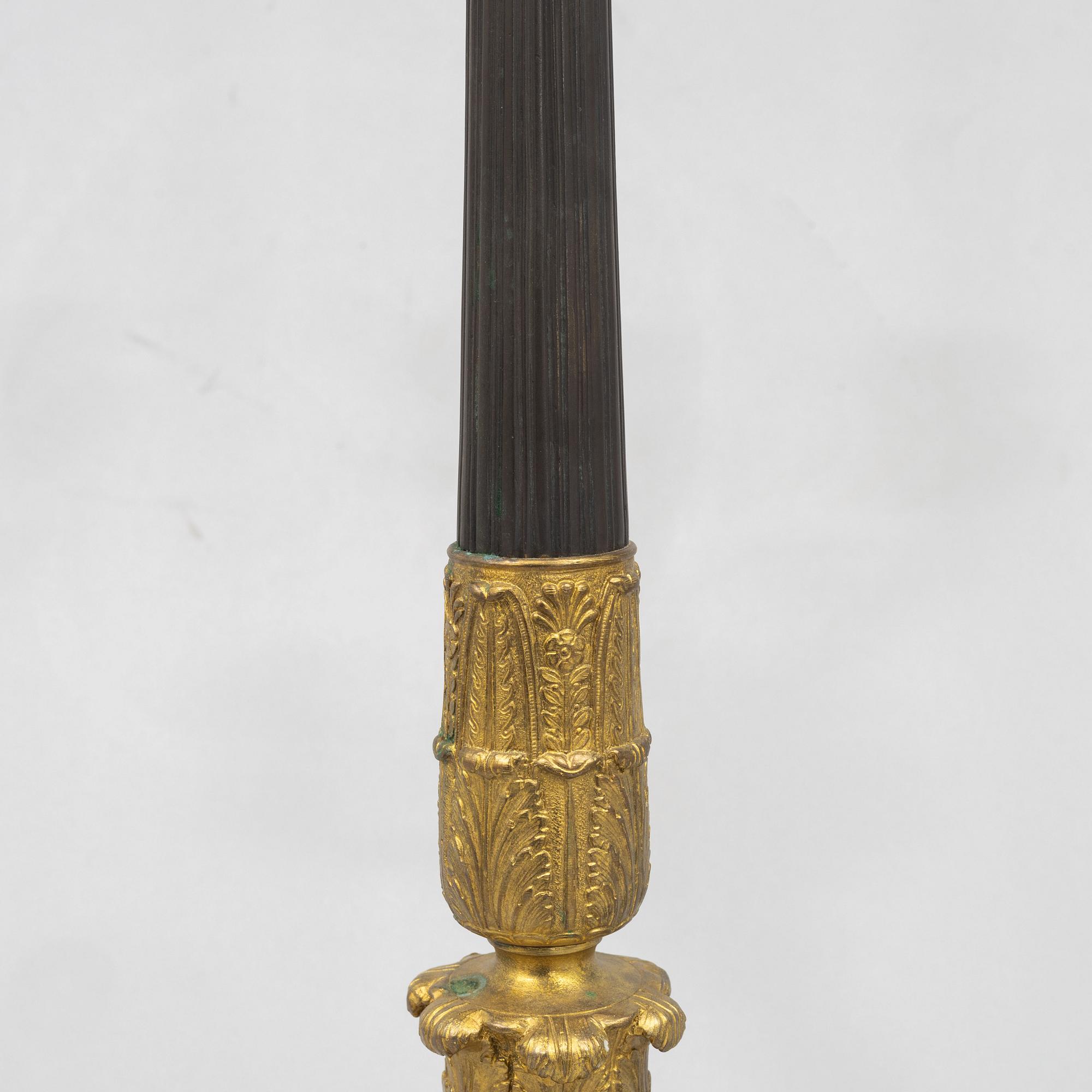 A pair of French Empire-style patinated and gilt bronze five-light candelabra, later part 19th century.