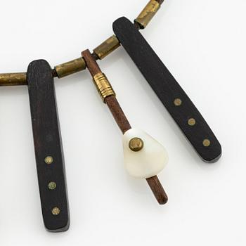 Vivianna Torun Bülow-Hübe, a necklace, wood, leather, mother-of-pearl and brass, most likely 1950's.