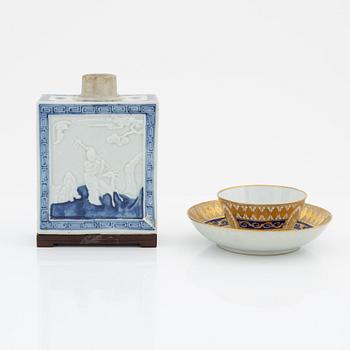 A blue and white porcelain tea cady, late Qing dynasty, 19th century, and a porcelain cup with saucer, Qing Dynasty, 19th century.