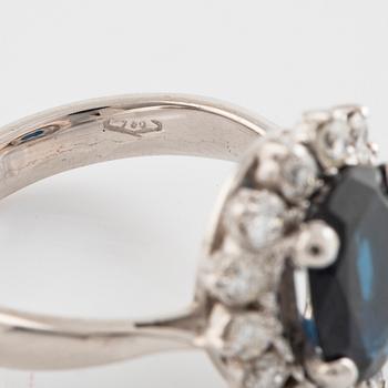 Dark sapphire and brilliant cut diamond ring.