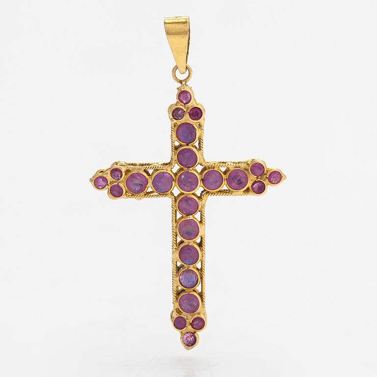An 18K gold cross pendant with sapphires. Finnish import marks.