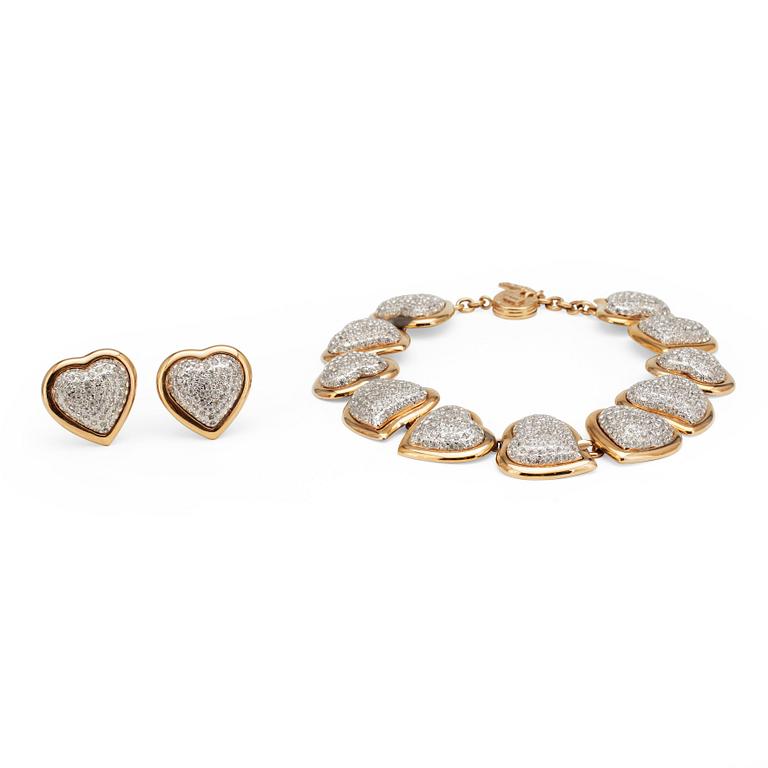 YVES SAINT LAURENT, a gold colored necklace and a pair of earclips.