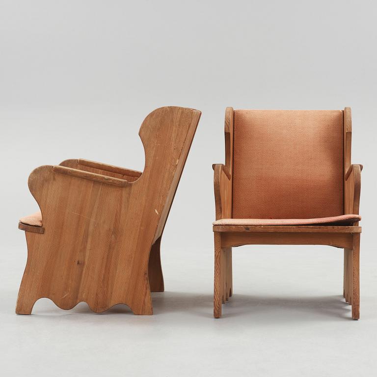 A pair of stained pine armchairs attributed to Axel Einar Hjorth, Nordiska Kompaniet, Sweden 1930's.