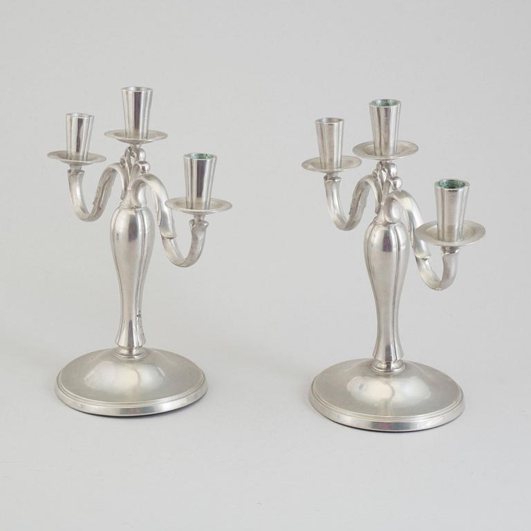 A pair of pewter candlesticks dated 1935.