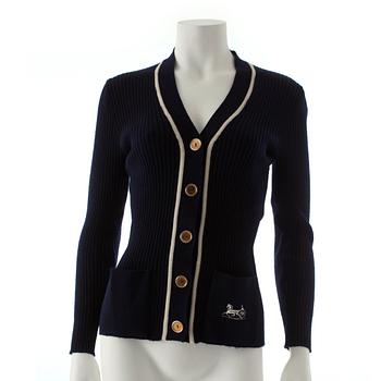CÉLINE, a navy blue cardigan.
